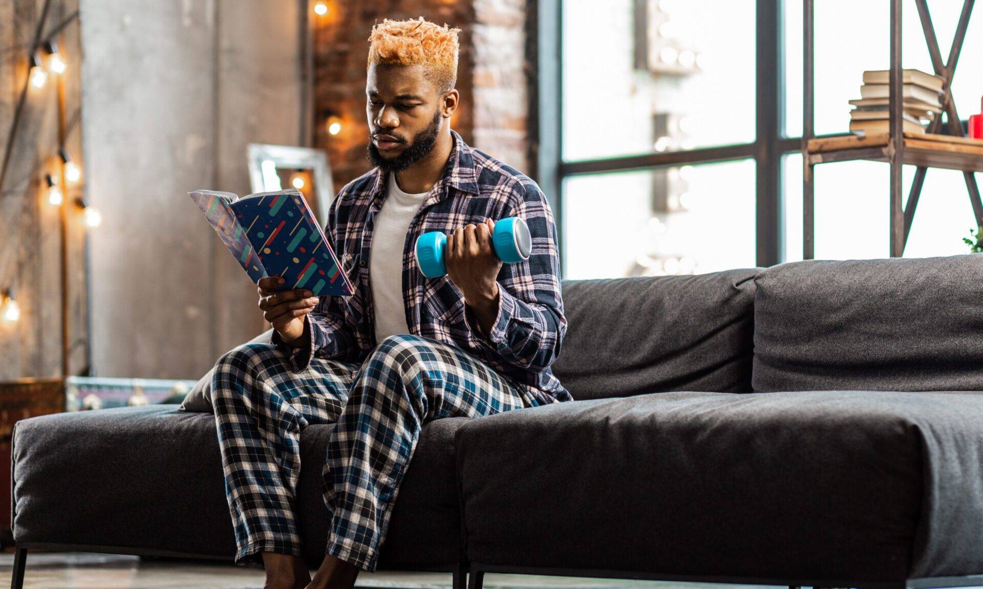 Nice serious man studying a book about sport