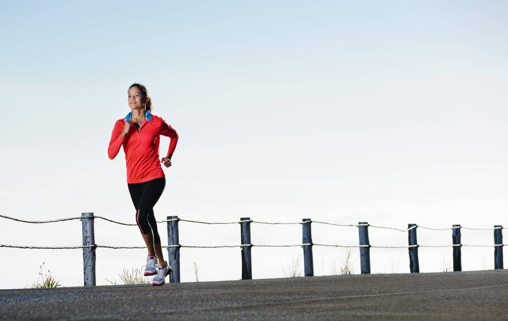 a woman is running on a road