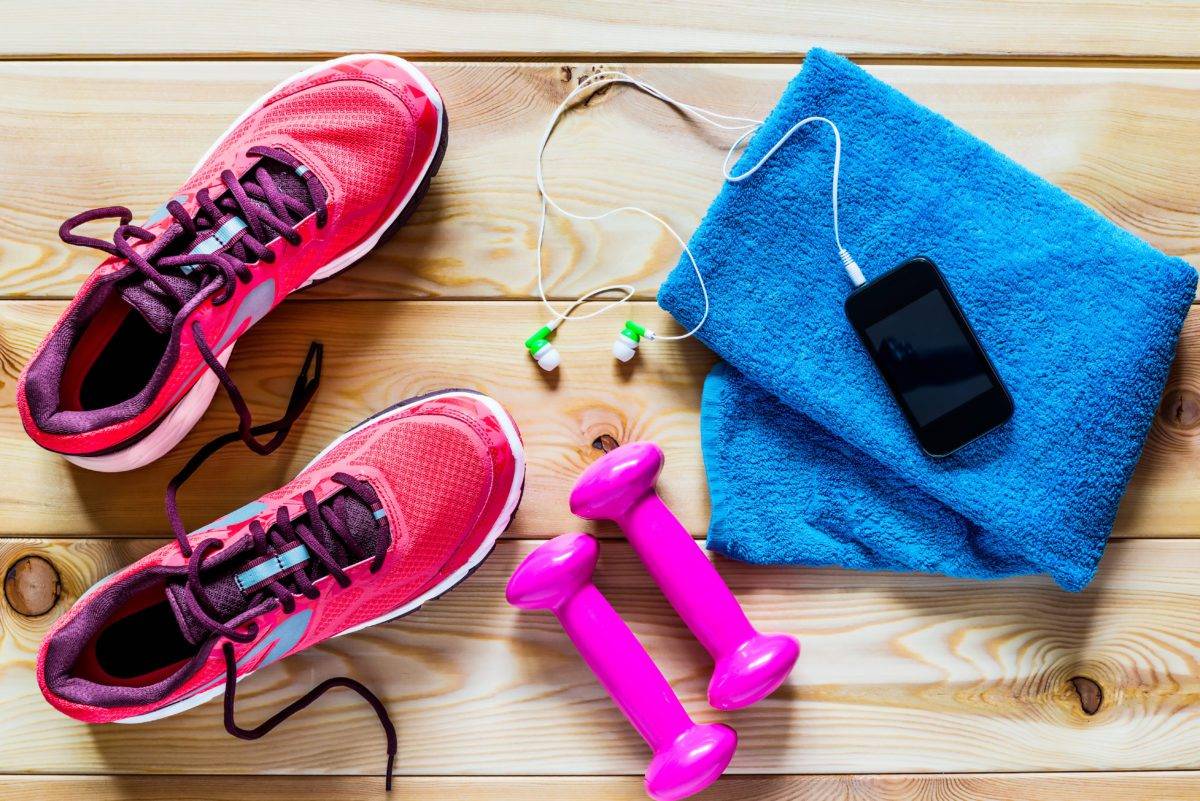 Women's running shoes and dumbbells for training